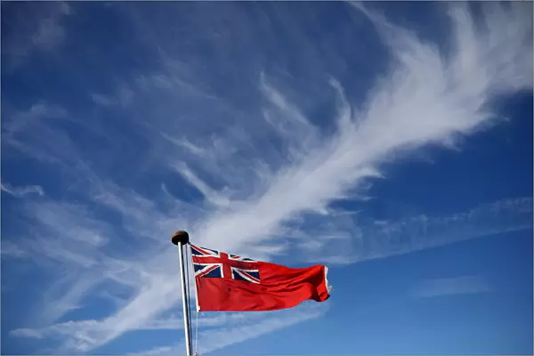 Cirrus clouds and some contrails are seen above a Red Ensign flag on the ferry MS