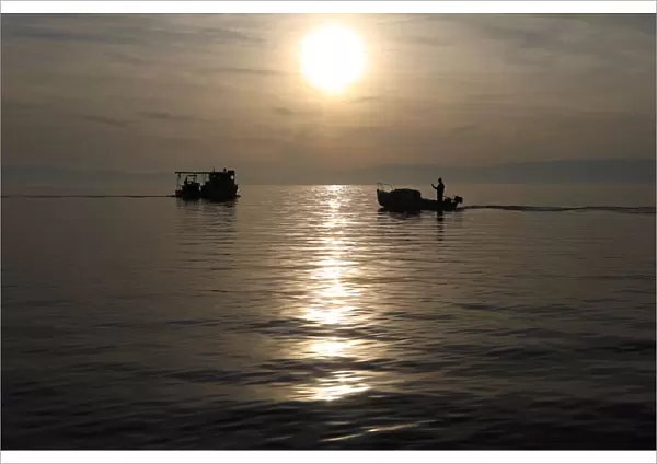 Fishermens boats are seen during a sunset in Kraljevica