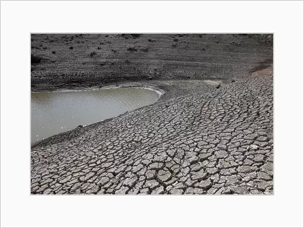 Dried mud is seen during a low-level period of water in Concepcion reservoir on the