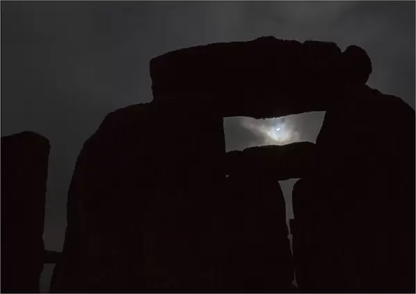 The solar eclipse is seen over Stonehenge on Salisbury Plain, Salisbury, southern England