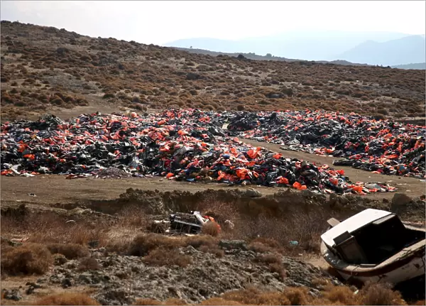 Thousands of lifejackets left by migrants and refugees are piled up at a garbage dump