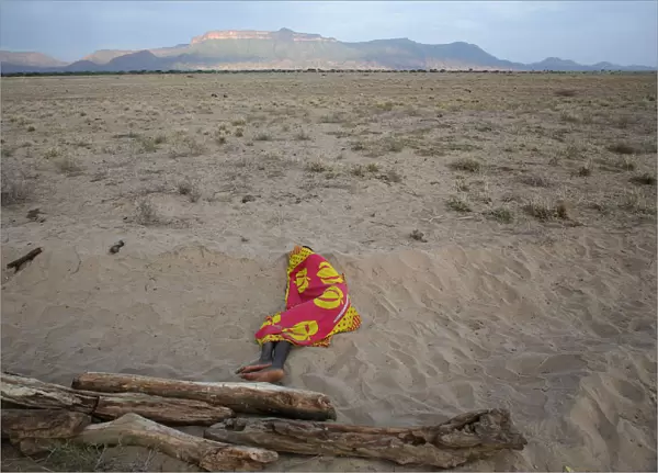 A Turkana man sleeps on the western shore of Lake Turkana close to Todonyang near the
