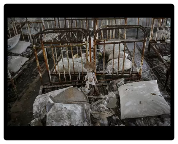A doll is seen amongst beds at a kindergarten in the abandoned city of Pripyat near the