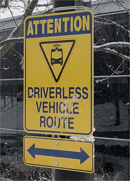 A sign marks part of a route used to test a driverless electric shuttle at the University