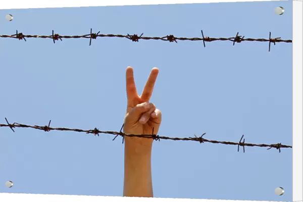 A Syrian flashes V-sign at a refugee camp in the Turkish border town of Altinozu in Hatay