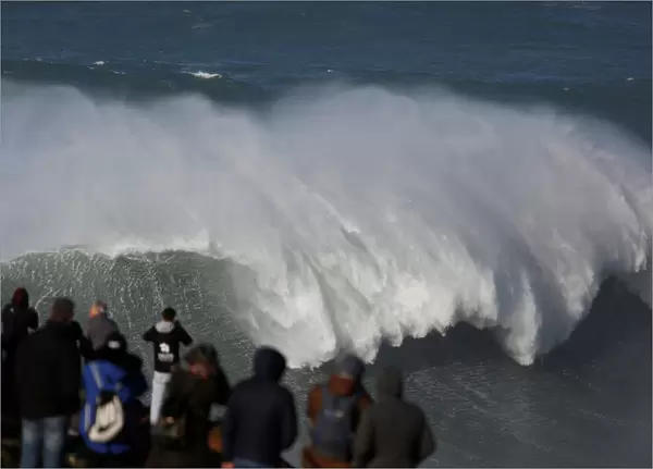 People gather to watch the Nazare Challenge championship at Praia do Norte in Nazare