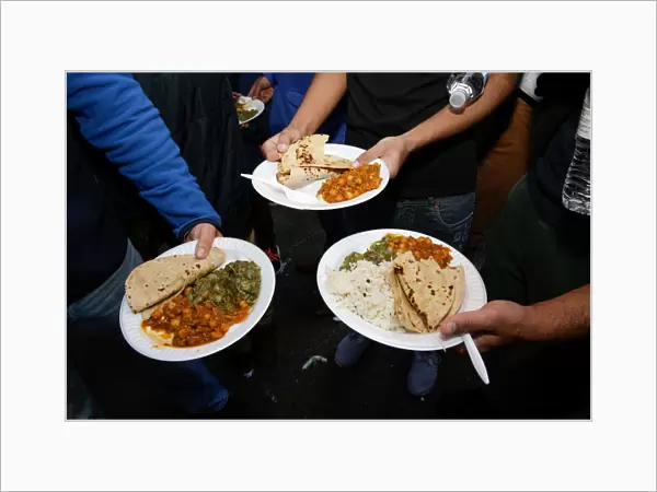 Free vegetarian meals are shown for the camera by participants at the Annual Sikh Day