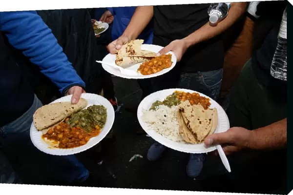 Free vegetarian meals are shown for the camera by participants at the Annual Sikh Day