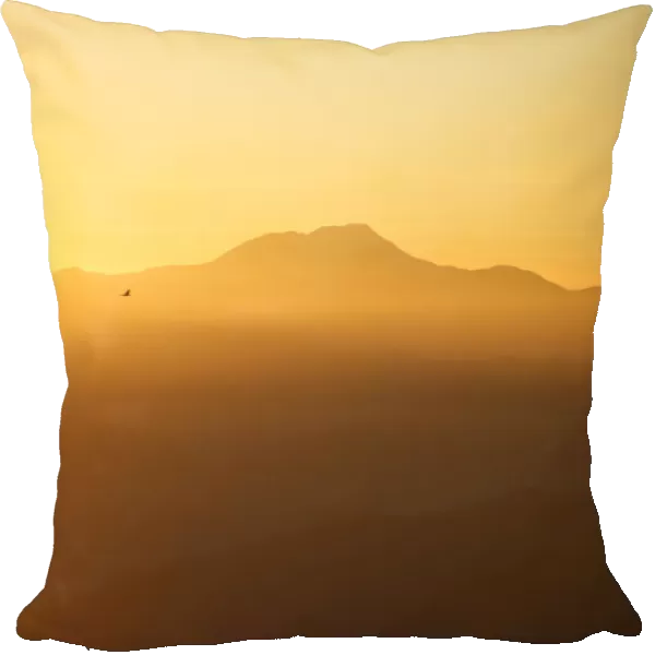 Light illuminates the mountain range and hills during the sunrise over the Nagarkot