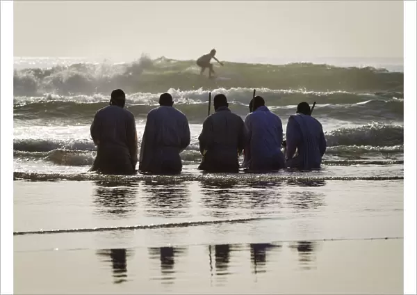 Members of the Shembe Church pray while kneeling in water on the Durban beach front