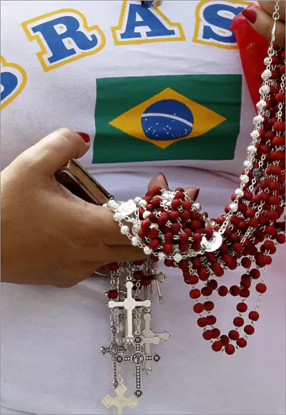 A Brazilian faithful holds rosaries as Pope Benedict XVI leads the Sunday Angelus prayer
