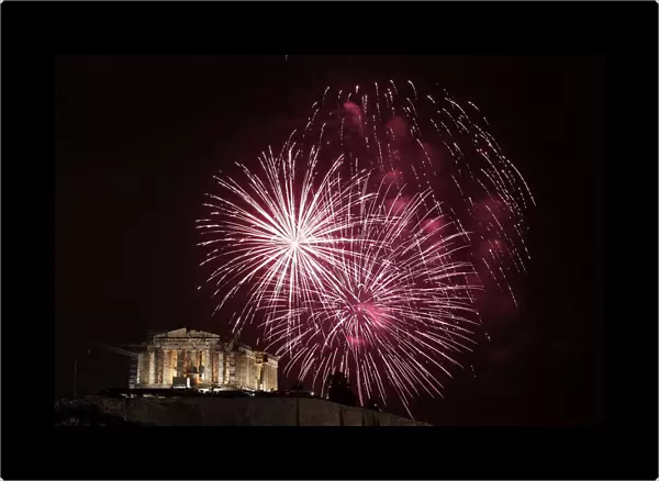 Fireworks explode over the temple of the Parthenon during New Year celebrations in Athens