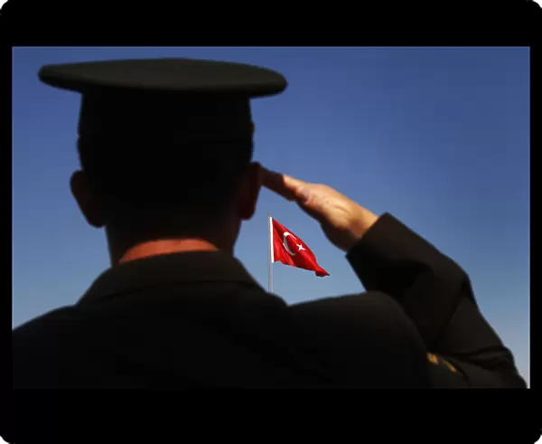 A soldier salutes the Turkish flag during a parade to mark the 88th anniversary of