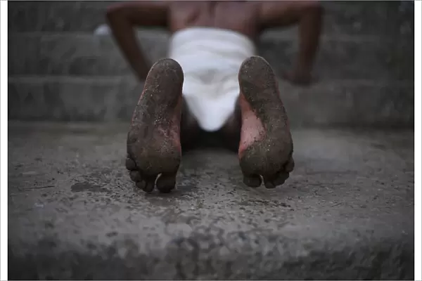 A Hindu devotees feet are seen while he rolls on the ground during the first day of