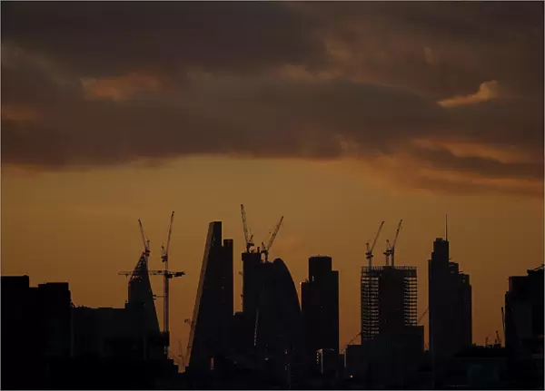 Skyscrapers stand at sunset in the city of Londons financial district in London