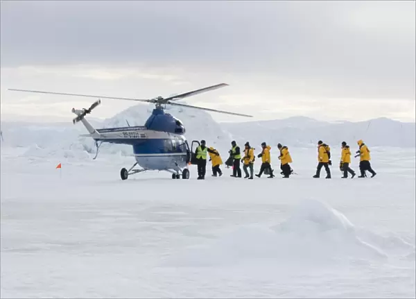 02603dt. Eco-tourists boarding helicopter to be taken back to Kapitan Klebnikov Icebreaker