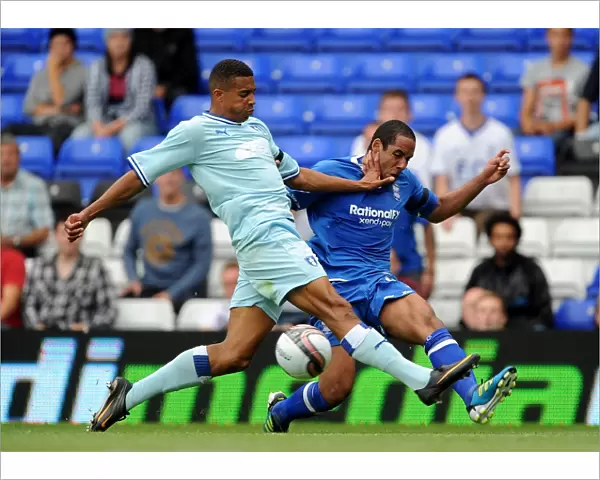 Birmingham City vs Coventry City: Intense Battle for the Ball - Cyrus Christie vs Jean Beausejour