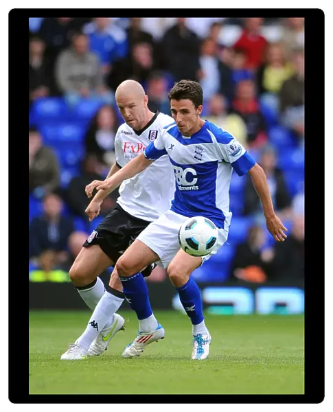 Intense Rivalry: Senderos vs. Derbyshire - A Battle for Ball Possession (Birmingham City vs. Fulham, Premier League, 15-05-2011)