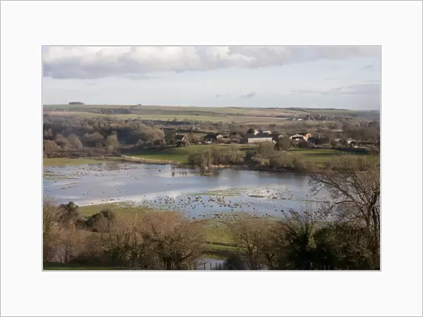 View of flooded fields around river, River Adur, Arun Valley, Amberley, West Sussex, England, February 2014