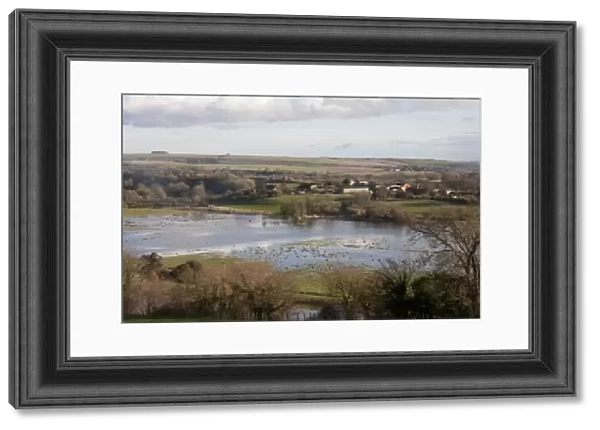 View of flooded fields around river, River Adur, Arun Valley, Amberley, West Sussex, England, February 2014
