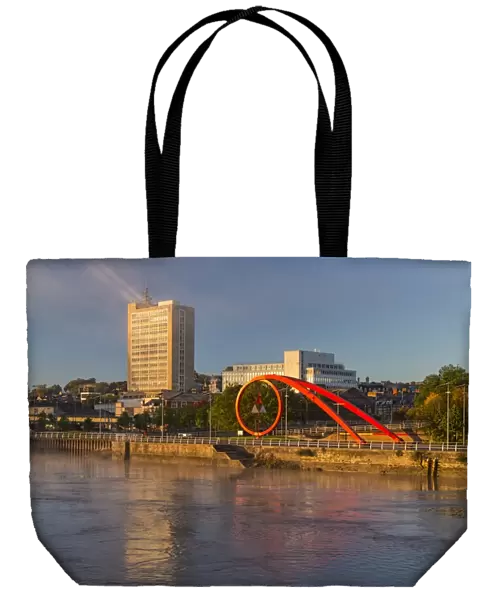 Steel sculpture on city waterfront at dawn, The Wave, River Usk, Newport, South Wales, October