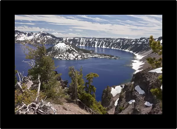 View of snow on volcanic cinder cone forming island in caldera lake at 7000ft. (2200m), Wizard Island, Crater Lake, Crater Lake N. P. Cascade Mountains, Oregon, U. S. A. july