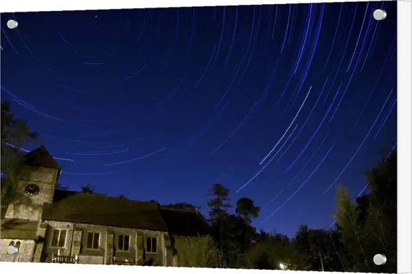 Stars revolving around Polaris (Pole Star) over church at night, Farnborough Church, Farnborough, Kent, England