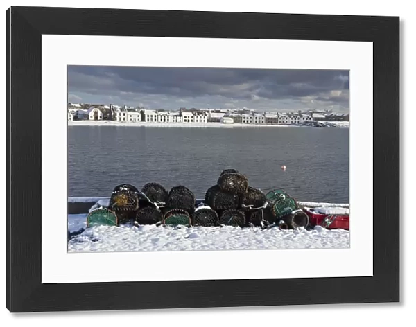 Lobster creels and snow covered seaside town, Port Ellen, Loch Leodamais, Isle of Islay, Inner Hebrides, Scotland