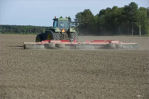 Tractor with rollers, rolling arable field, Tierp, Sweden, may