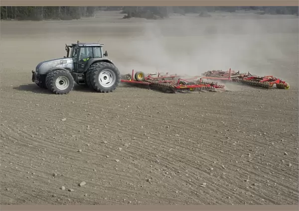 Valtra tractor with Vaderstad NZA-800 and Vaderstad RS-820 harrows and rollers, cultivating arable field, Sweden, april