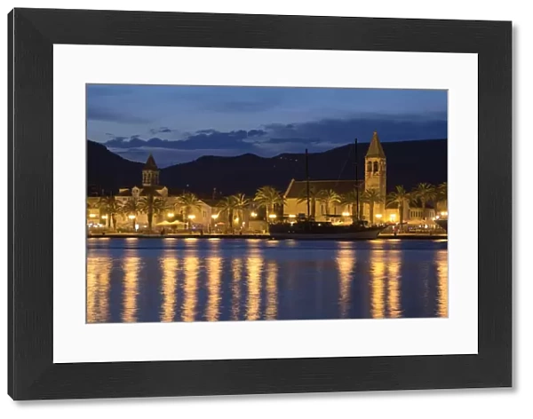 View of old town and harbour with Catholic church and palm trees at night, Trogir, Dalmatia, Croatia, July