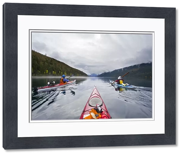 Canada, British Columbia, Bowron Lakes Provincial Park. Sea kayakers on 24-mile long Isaac Lake