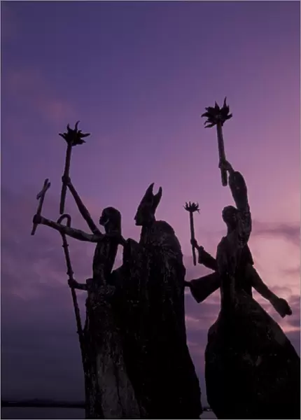 CARIBBEAN, Puerto Rico Slender statues on coatline at dusk