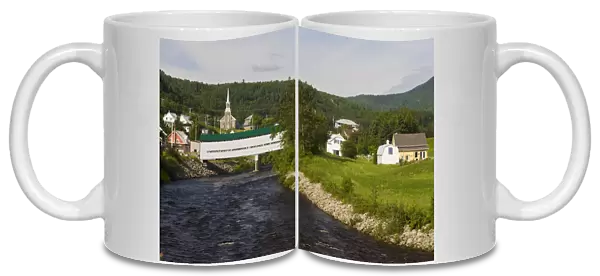 Fauberg covered bridge and the village of l Anse St. Jean in the Saguenay River