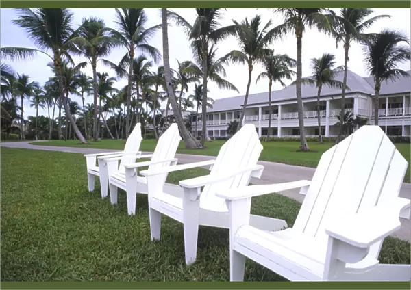 Classic white Adirondack chairs at the Elegant Ocean Club in Paradise Islands Bahamas