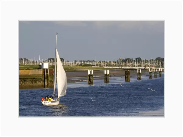 A sail boat at Nieuwpoort harbor entrance in the province of West Flanders, Belgium