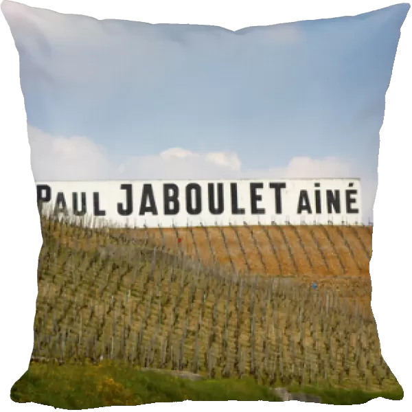 A big white sign with black letters Paul Jaboulet Aine against a blue sky, in front