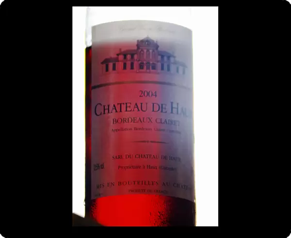 A bottle of Chateau de Haux rose clairet wine backlit Chateau de Haux Premieres