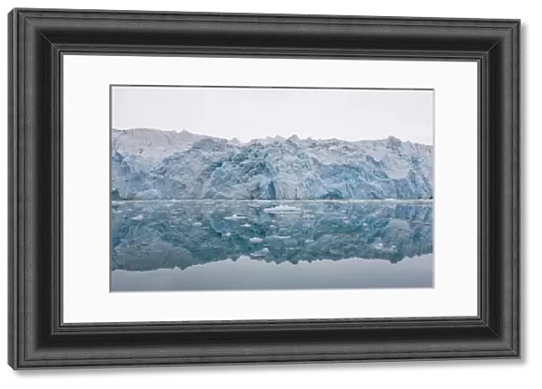 Norway, Svalbard, Spitsbergen, Ice face of Lilliehook Glacier reflected in calm