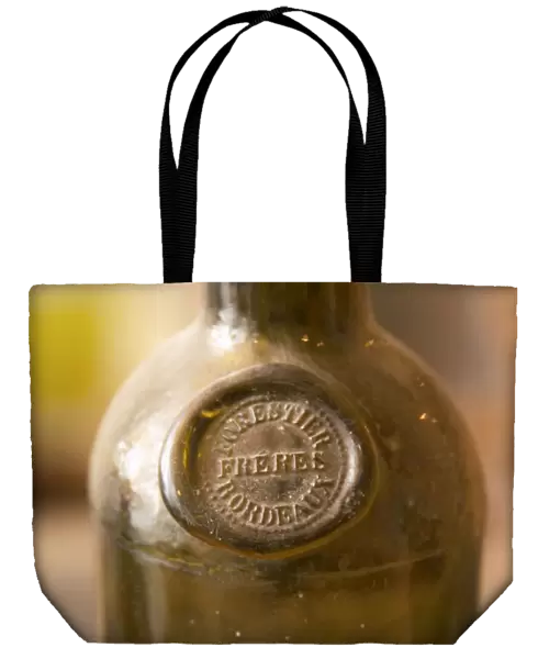 An old antique dusty wine bottle with a moulded seal on the shoulder of the bottle