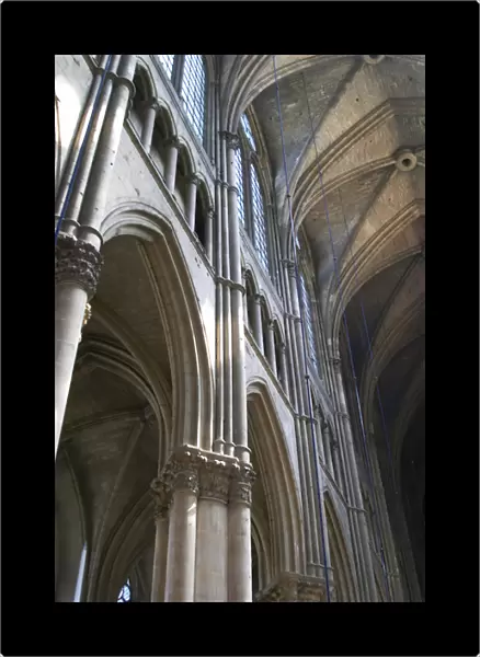 The Reims cathedral with its high gothic arched vaults and sun shining through the