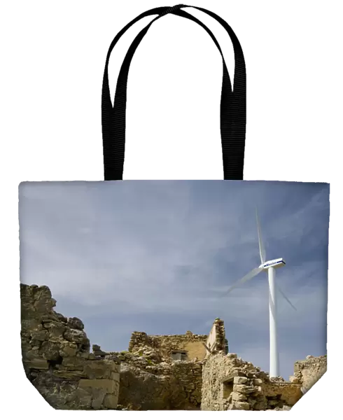 Crete. Greece. Europe. Wind turbine of Plastika Kritis wind farm towers above ruins