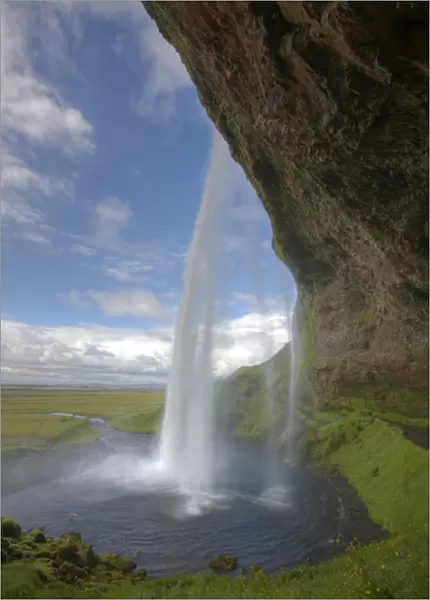 Iceland, Selfoss. Scenic from behind the Seljalandsfoss waterfall. Credit as: Josh