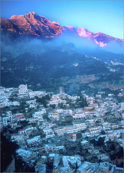 Europe, Italy, Positano. Sun hits the mountain peaks along the Amalfi Coast