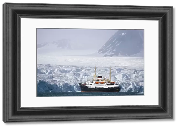 cruise ship in front of large glacier, June