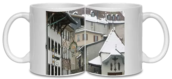 SWITZERLAND-Fribourg-GRUYERES: Buildings along Main Street  /  Winter