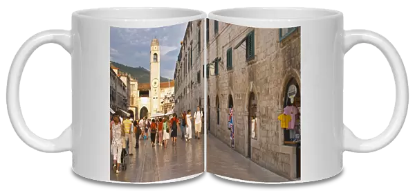 The main street Stradun Placa with traditional houses, view over clock tower