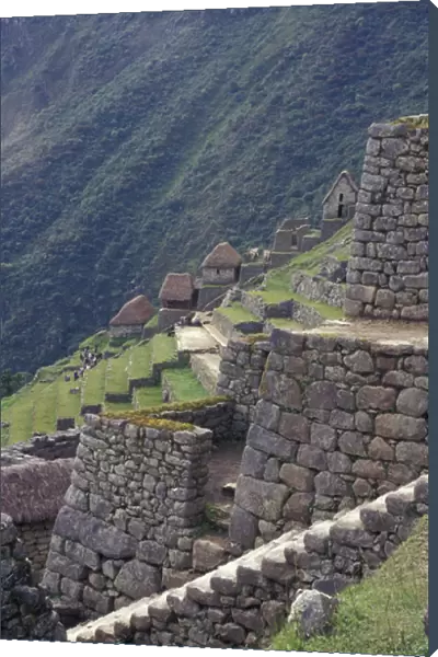 SA, Peru, Machu Picchu Stone walls and terraces of Incan ruins high in Andes Mountains