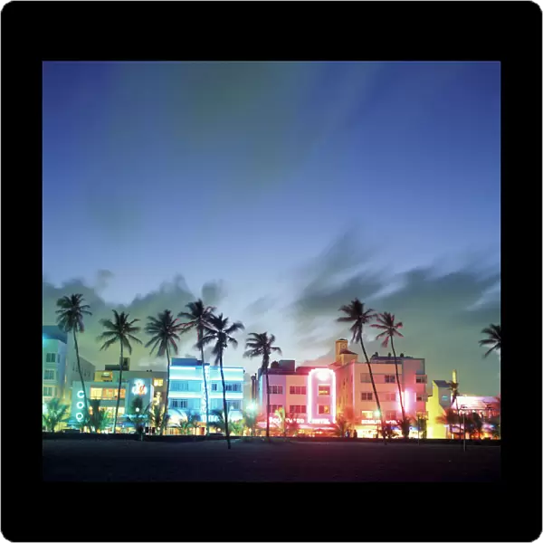 N. A. USA, Florida, Miami, South Beach. Art Deco architecture and palm trees along the strip