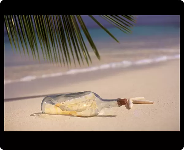 USA, Hawaiian Islands. Message in a bottle on the sands of a tropical beach